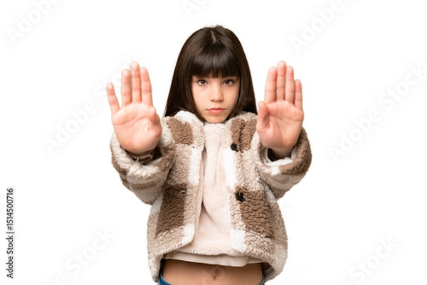 Fototapeta Little girl over isolated green chroma key background making stop gesture and disappointed
