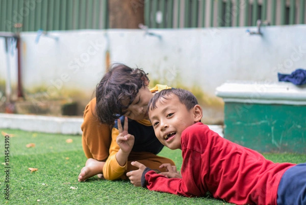 Obraz Portrait of two little children at park full of grass