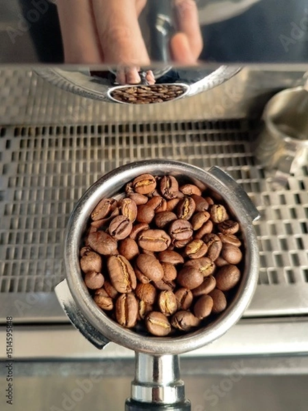 Obraz coffee beans in a holder on a coffee machine background