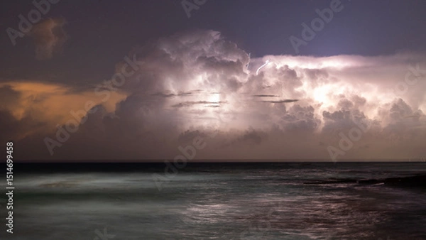 Fototapeta lightning over sea in the night