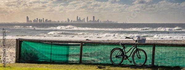 Obraz A bicycle on Kirra Beach with the Surfers Paradise skyline on the horizon. Queensland, Australia.