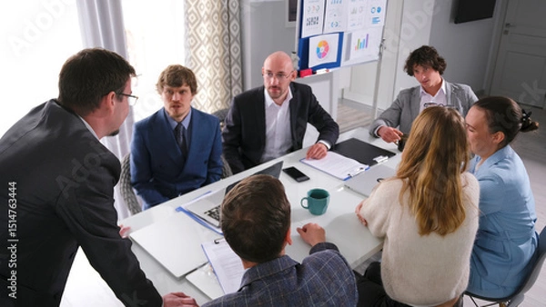 Fototapeta The concept of discussing the terms of cooperation and business development of the company. Young professionals