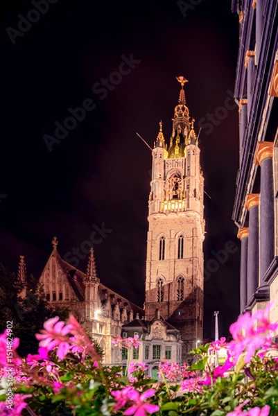 Fototapeta Tower of the St Baaf's Cathedral in the illuminated city center of the Flemish city of Ghent