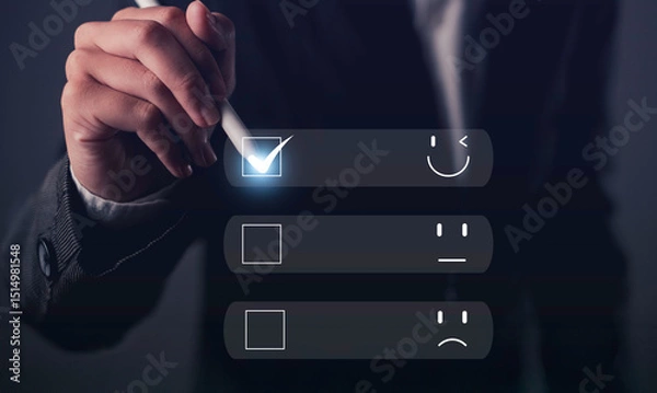 Fototapeta Hand holding stylus selecting happy face on digital satisfaction survey, representing positive feedback, customer experience, and user satisfaction.