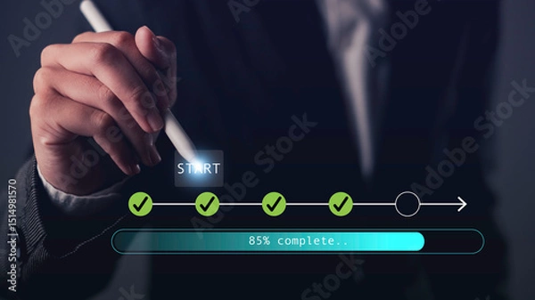 Obraz Hand holding stylus pointing at digital start button with progress bar and checklist icons, symbolizing process tracking, workflow progress, task completion, and digital planning.