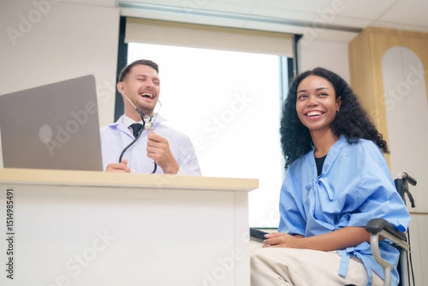 Obraz doctor in white gown with stethoscope,asking a woman patient on wheelchair a present illness and writing paper on clipboard to diagnosis and treatment