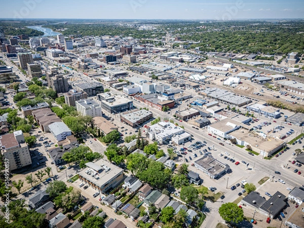 Fototapeta City view from above with many buildings and cars