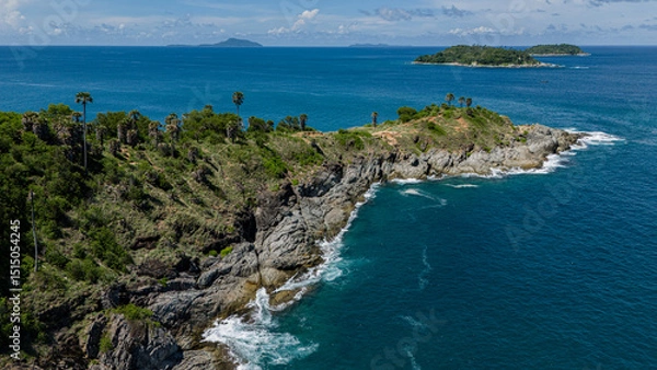 Fototapeta Picturesque small island located in the middle of the vast ocean surrounded by blue waters