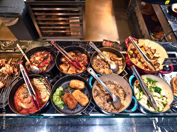 Fototapeta A large and diverse buffet that includes a wide variety of different types of delicious food.