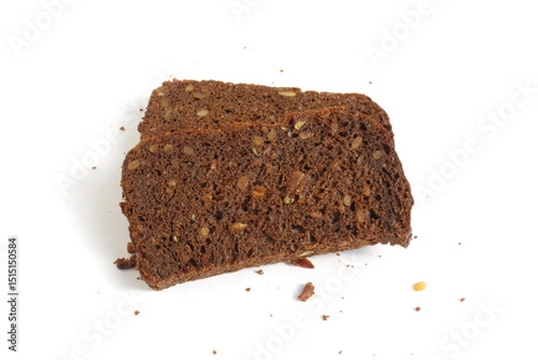 Obraz Pieces of black rye bread with sunflower seeds lie on a white background.