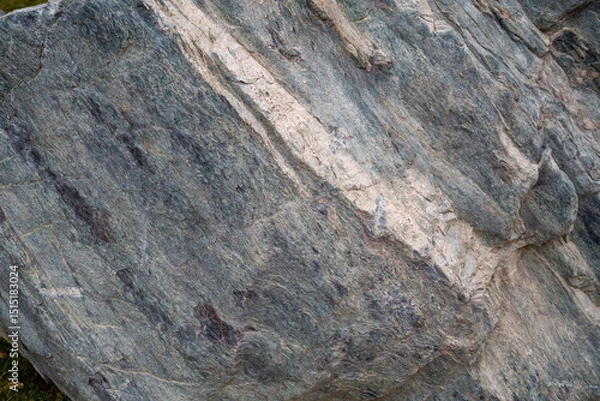 Fototapeta Stone Background. Textured metamorphic rock surface with visible striations. Geological and natural texture references.