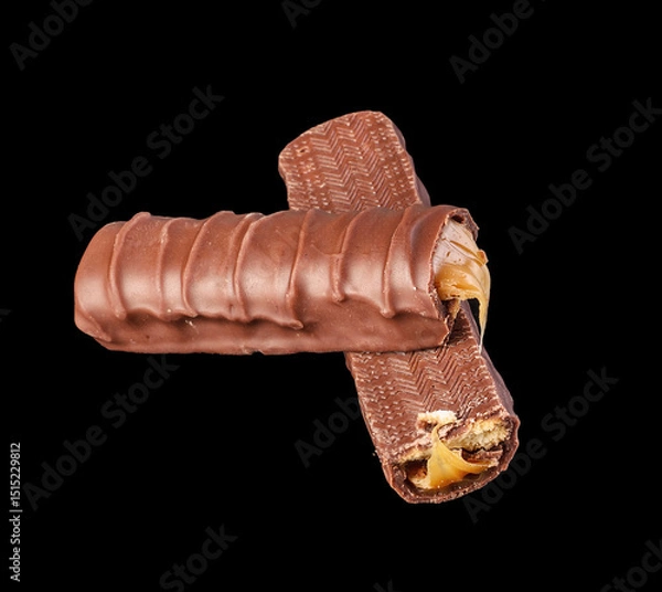 Fototapeta Chocolate bar on black background, abstract food concept