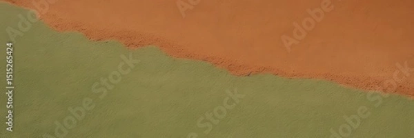 Fototapeta Abstract close-up of textured orange and green materials blending at the edge, creating a striking contrast and dynamic interplay between color, form, and surface detail. 