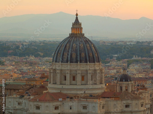 Obraz Golden sunrise over Vatican City with breathtaking view of St. Peter’s dome, soft mountain layers in background, harmony of faith, art, and history.