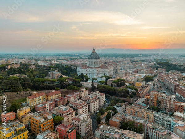 Obraz Peaceful cityscape of Rome at dusk, dominated by St. Peter’s Basilica’s towering dome, glowing against the warm and fading sunset sky. Travel concept