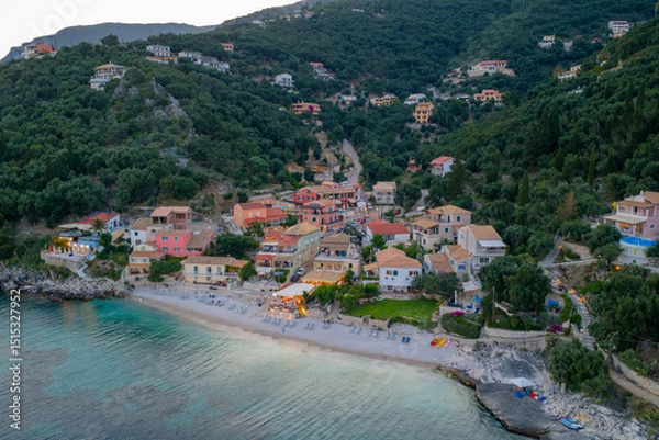 Fototapeta Seaside town nestled in lush green hills, with colorful buildings and a tranquil beach view. Serene.