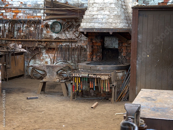 Fototapeta Rustic blacksmith workshop with tools and forge.
