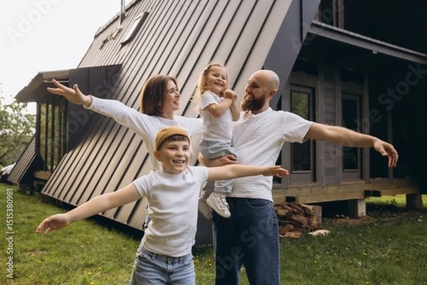 Obraz Happy family enjoying their new sustainable home