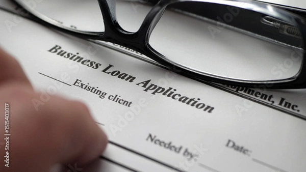 Obraz Finger tapping on business loan application