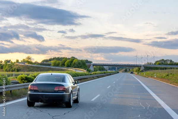 Obraz Car on highway. Road through greenery. Evening drive