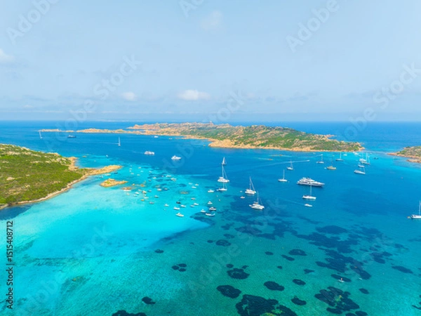 Fototapeta Island in the middle of the sea. Drone view of a yachts, boats and island. Vacationing people. North-Eastern Sardinia, Maddalena Archipelago. Vacation and holidays. Background, wallpaper, postcard.