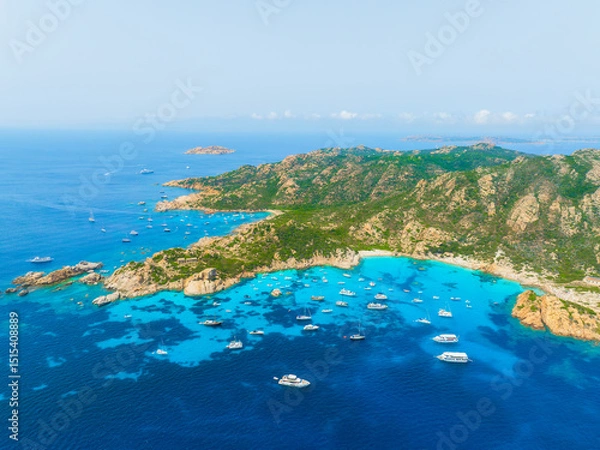 Fototapeta Island in the middle of the sea. Drone view of a yachts, boats and island. Vacationing people. North-Eastern Sardinia, Maddalena Archipelago. Vacation and holidays. Background, wallpaper, postcard.