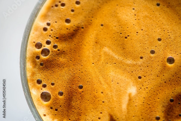 Fototapeta Coffee cup from above, Espresso foam texture, creamy coffee, rich, freshly brewed cup of hot latte. Top view of cappuccino milk foam closeup. Creamy coffee macro shot, on a grey table, top view. 