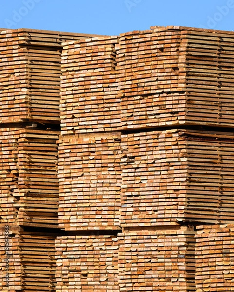Fototapeta Industrial stack of processed lumber boards end view