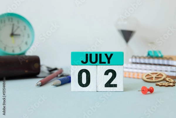 Fototapeta Close up of a wooden perpetual calendar showing the 2nd of July.