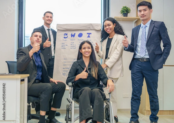 Obraz corporate diverse business people and business person with disability meeting, discussing,analysis new business strategy by using flipchart in boardroom