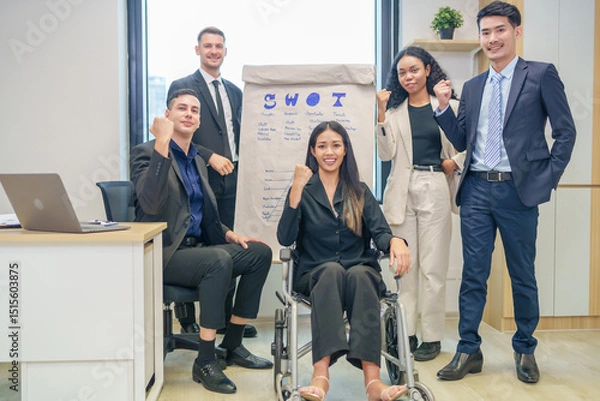 Obraz corporate diverse business people and business person with disability meeting, discussing,analysis new business strategy by using flipchart in boardroom