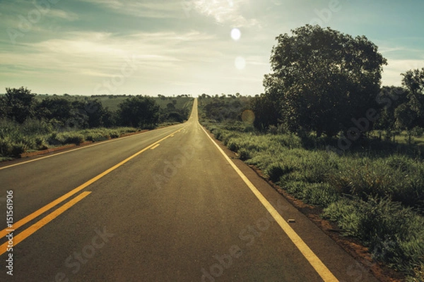 Fototapeta Vintage toned Highway with fields around