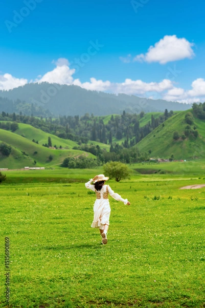 Fototapeta Young woman traveler relaxing and enjoying beautiful Scenery landscape with flowers in Nalati grassland of Xinjiang in summer