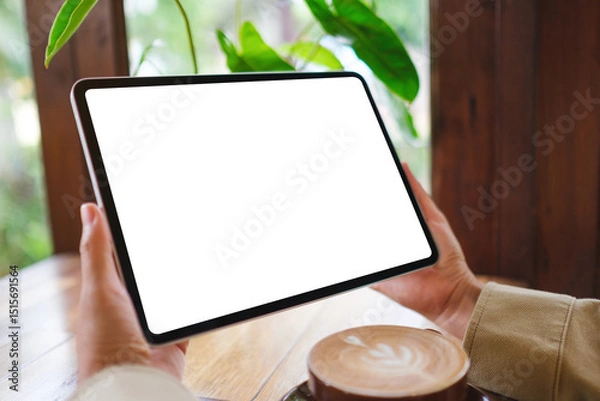 Fototapeta Mockup image of a woman holding digital tablet with blank white desktop screen