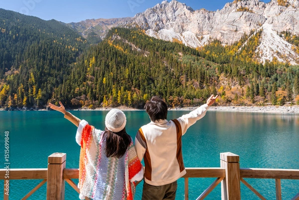 Fototapeta Young couple tourist relaxing and enjoying with beautiful colorful autumn leaves and nature scenic view of Long Lake in Jiuzhaigou national park