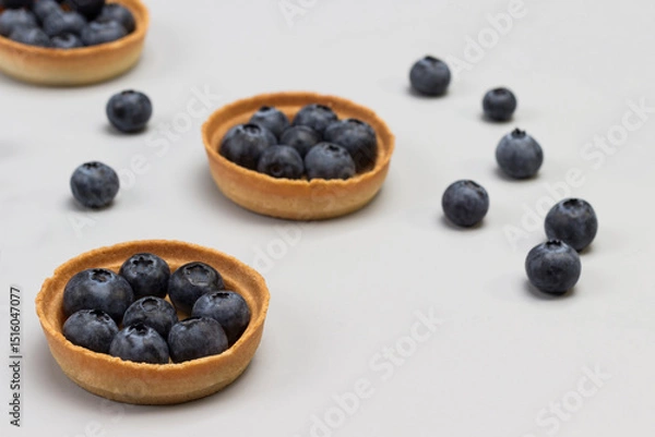 Fototapeta Tartlets with blueberries. Blueberries on table