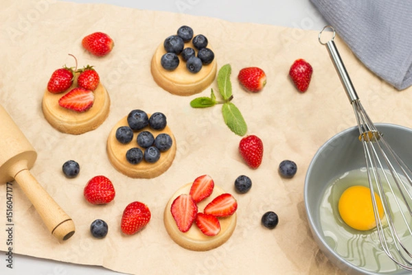 Fototapeta Blueberries and blueberries on table. Tartlets with berries on brown paper.
