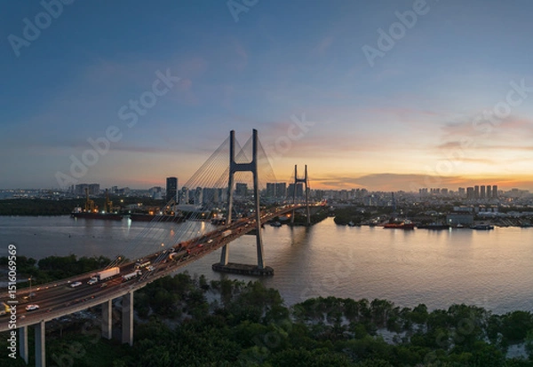 Fototapeta Stunning view of Phu My bridge at sunset over the river in Ho Chi Minh city, showcasing urban life and bustling traffic