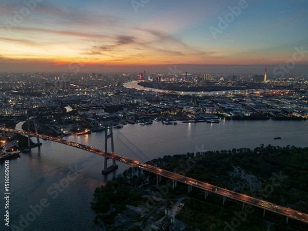 Fototapeta Phu My bridge illuminated at dusk over the Saigon River in Ho Chi Minh City, Vietnam