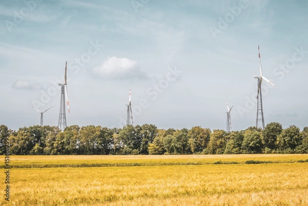Fototapeta Wind Turbines with Wheat Field and Forest – Renewable Energy in Bramsche-Achmer, Germany