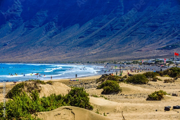Obraz Surfers beach Famara on Lanzarote always has a red flag.