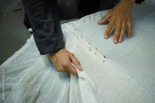 Fototapeta Partial shot of craftswoman fastening rug canvas on frame