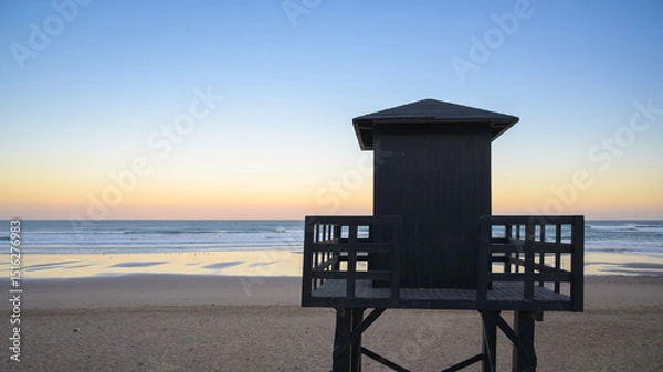 Fototapeta Lifeguard tower on the beach in Sidi Ifni during sunset overlooking the Atlantic Ocean