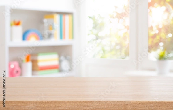 Fototapeta Wooden table top for educational purposes on blurred bookshelf and autumn window interior background. Original work - no AI used