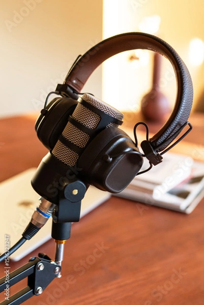 Fototapeta Podcast studio setup with microphone and headphones ready for live broadcast in a cozy workspace