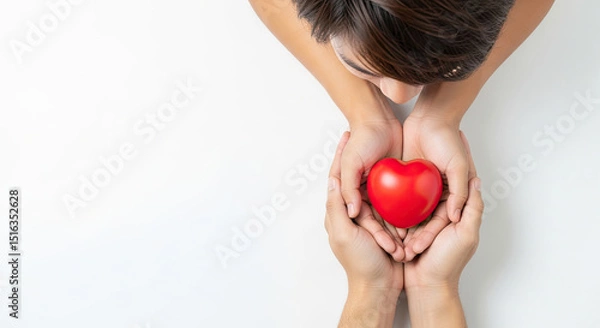 Obraz Gentle hands sharing a vibrant red heart symbolizing love care and compassion