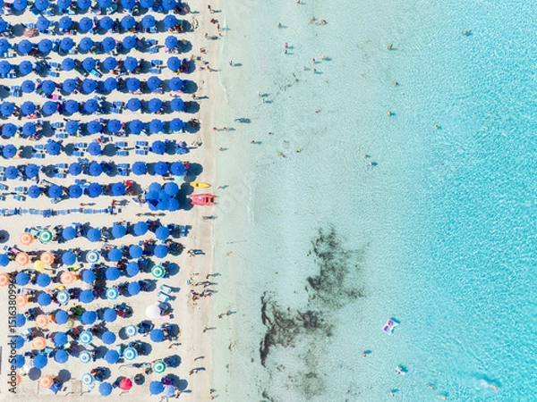 Fototapeta Summer vacation and rest. Beach, people and umbrellas. Top view from drone at the beach and azure sea. View on the coast from drone. Background, wallpaper, postcards.
