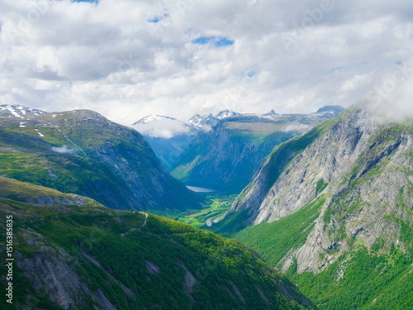 Fototapeta Norwegian fjord. High mountains and forest. Clouds over the rocks. Vacation and travel in summer Norway. Wallpaper, postcard, background. Place for mountain hiking, travel and vacation.