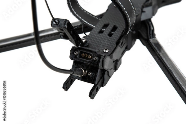 Fototapeta Close-up of a rear power connector and antenna port on a carbon fiber FPV racing drone, isolated on white back
