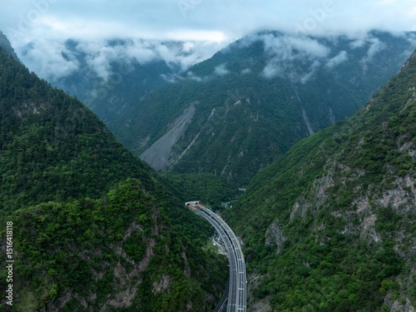 Fototapeta Aerial view of  beautiful foggy forest mountain and highway landscape